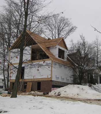 Home Additions - Photo of a home addition being built in the winter by Tamer Construction.