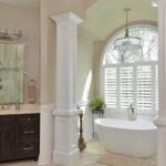 Bathroom Remodel - Photo of a beautiful remodeled bathroom tub with arched window in background.